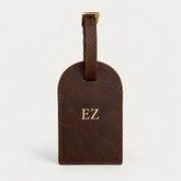 Round Luggage Tag — Grecorium leather accessory on a neutral background