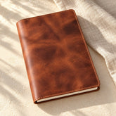 Closed brown refillable Grecorium A5 leather notebook cover on ivory linen