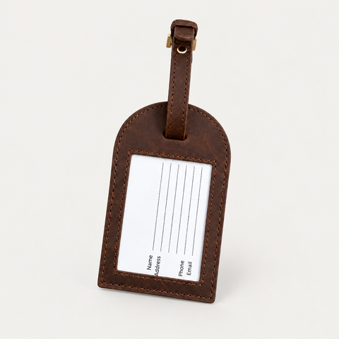 Round Luggage Tag detail — Grecorium leather accessory on a neutral background