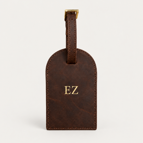 Round Luggage Tag — Grecorium leather accessory on a neutral background