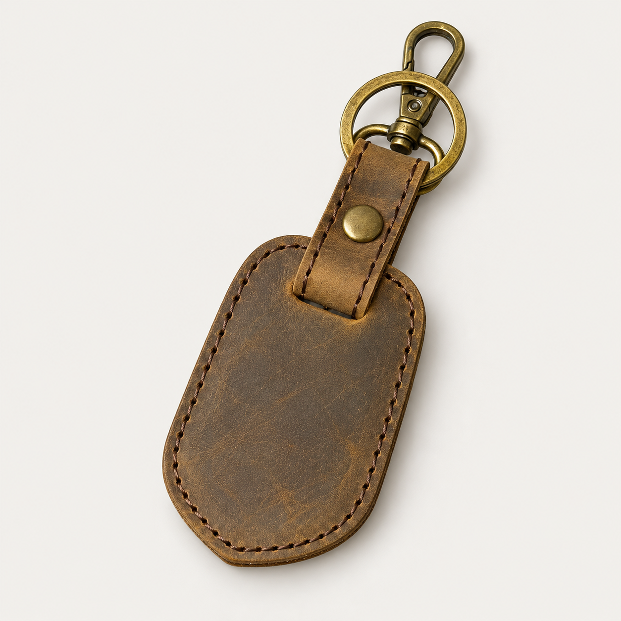 Shield Keychain No. 4 — Grecorium leather accessory on a neutral background