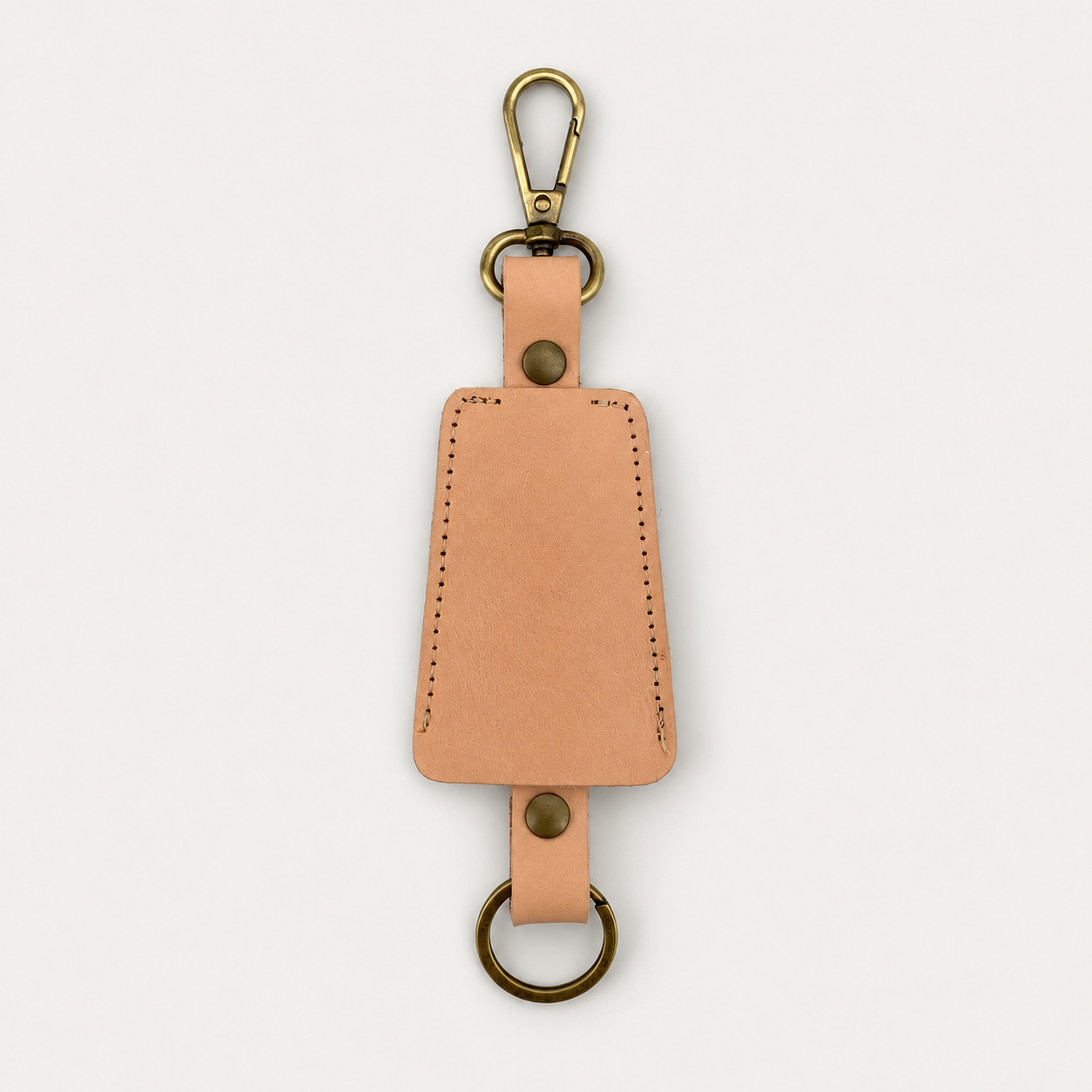 Bell Keychain detail — Grecorium leather accessory on a neutral background
