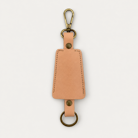 Bell Keychain detail — Grecorium leather accessory on a neutral background