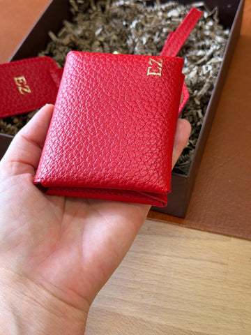 Close-up of the red double cardholder and matching personalised luggage tag