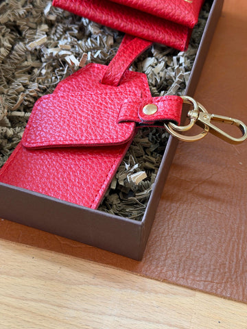 Back of the red luggage tag with its matching attachment strap